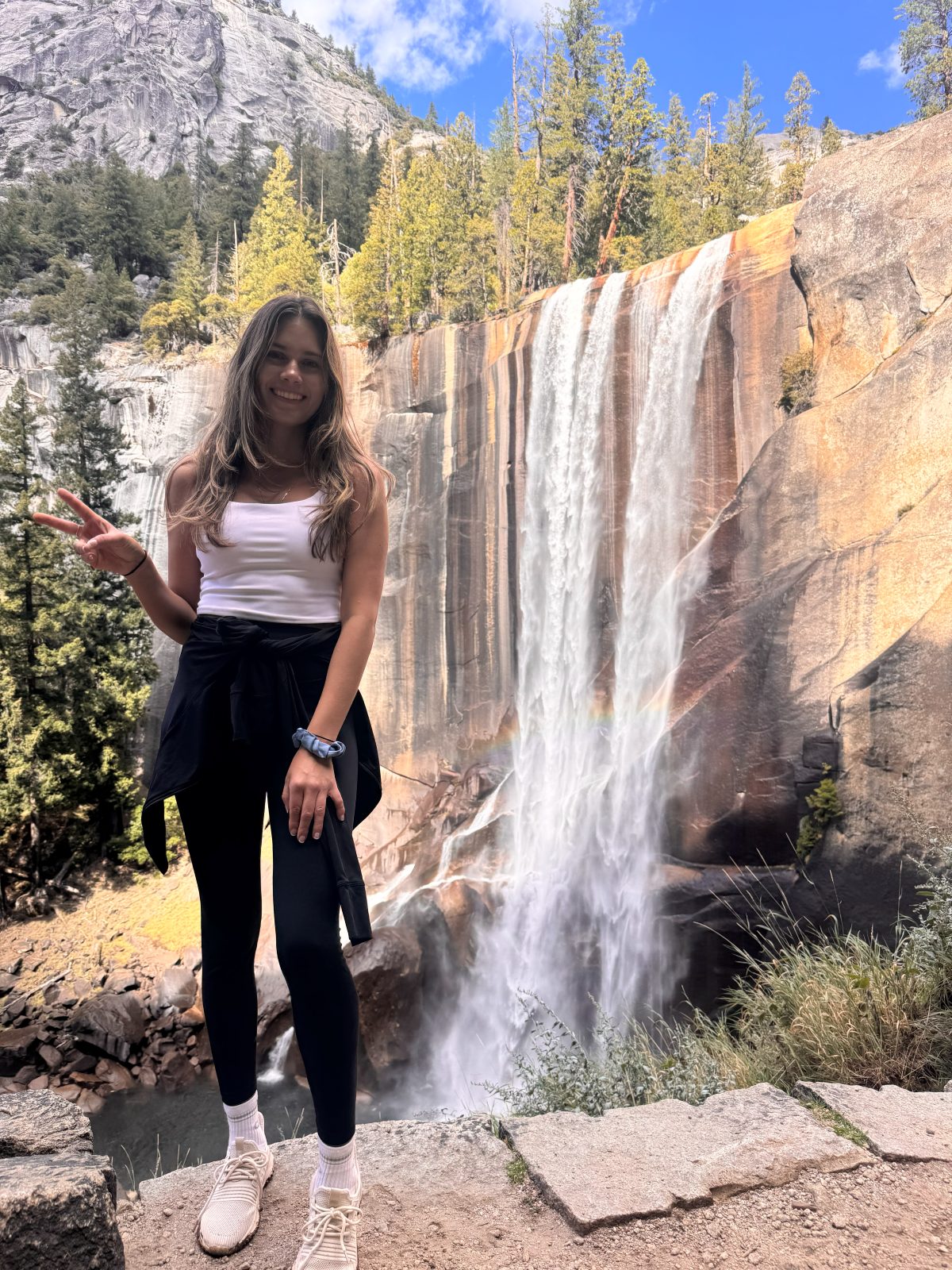 Hiking beside a waterfall in Yosemite