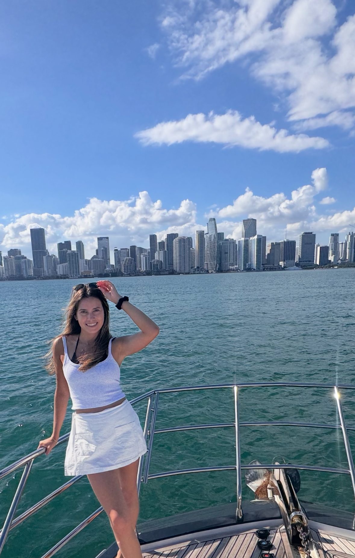 On the bow of a boat with the Miami skyline behind