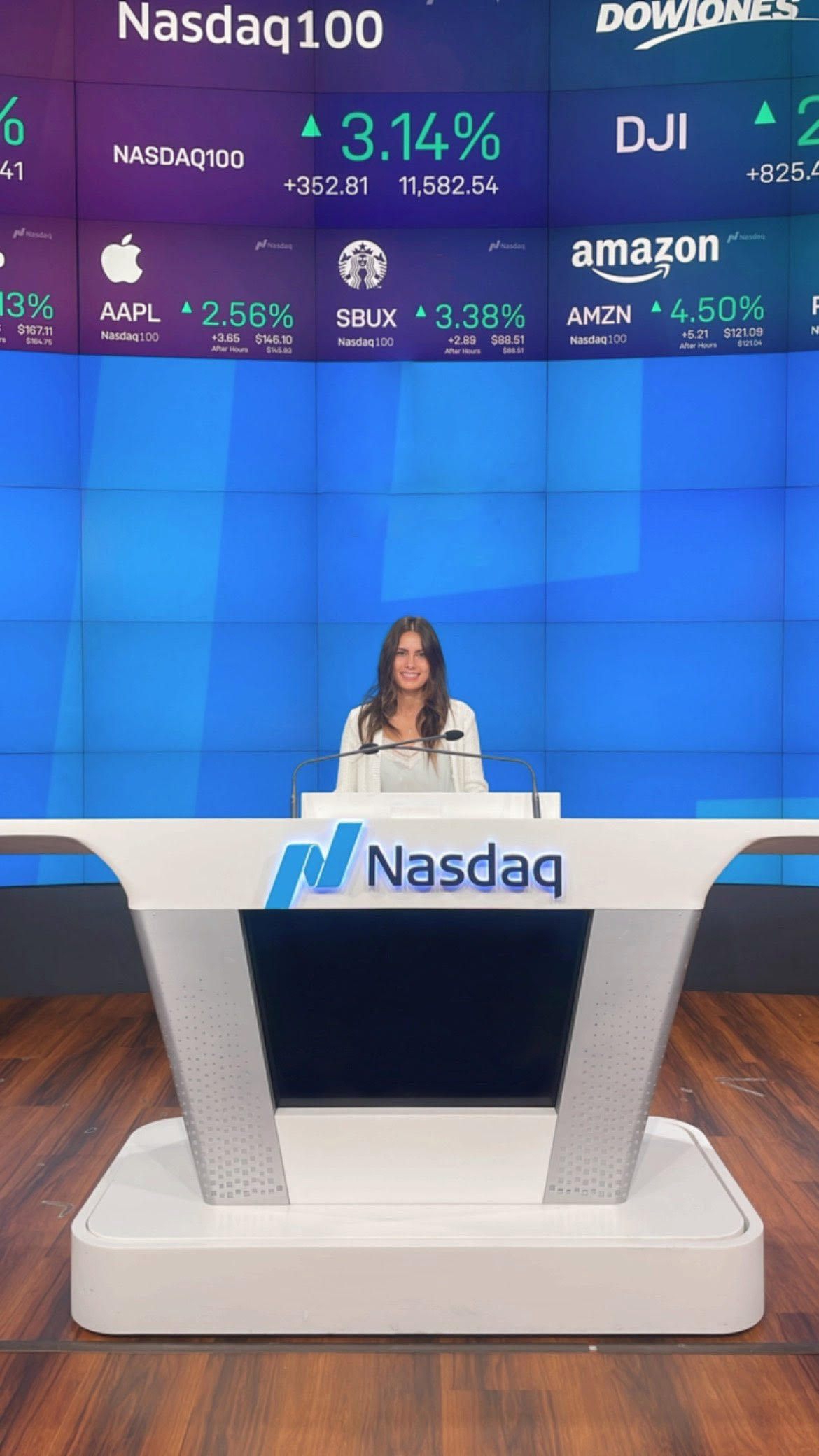 At the Nasdaq MarketSite podium in front of the ticker wall